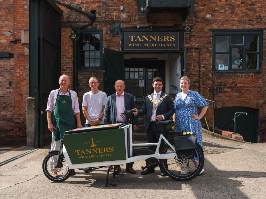 Members of staff from Tanners, Shrewsbury BID, along with Shrewsbury Mayor Alex Wagner and eCargo Bike provider Dave Mellor pose in front of a branded ecargo bike at Tanners Shrewsbury